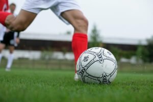 Soccer player kicking a ball during a match