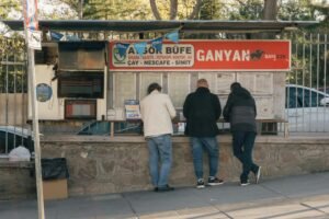 People checking sports odds at a betting kiosk